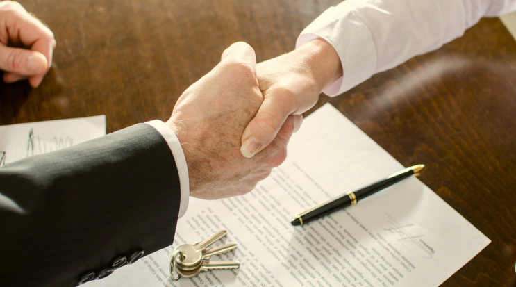 appraiser and client shaking hands keys paper and pen on table catawissa pa